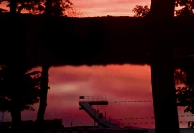 Picture of a dock with a sunset in the background.